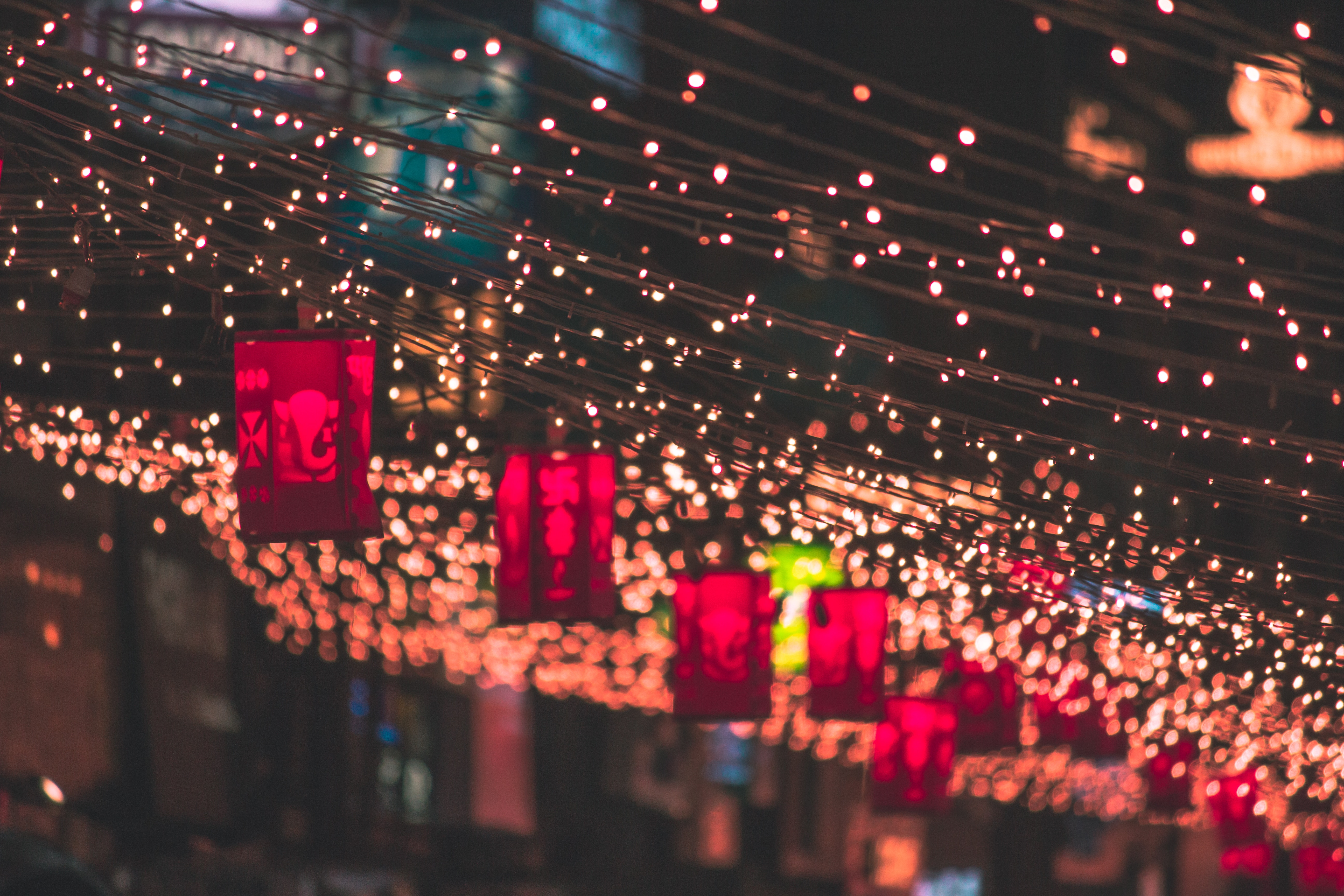 close up of hanging red lanterns and string lights