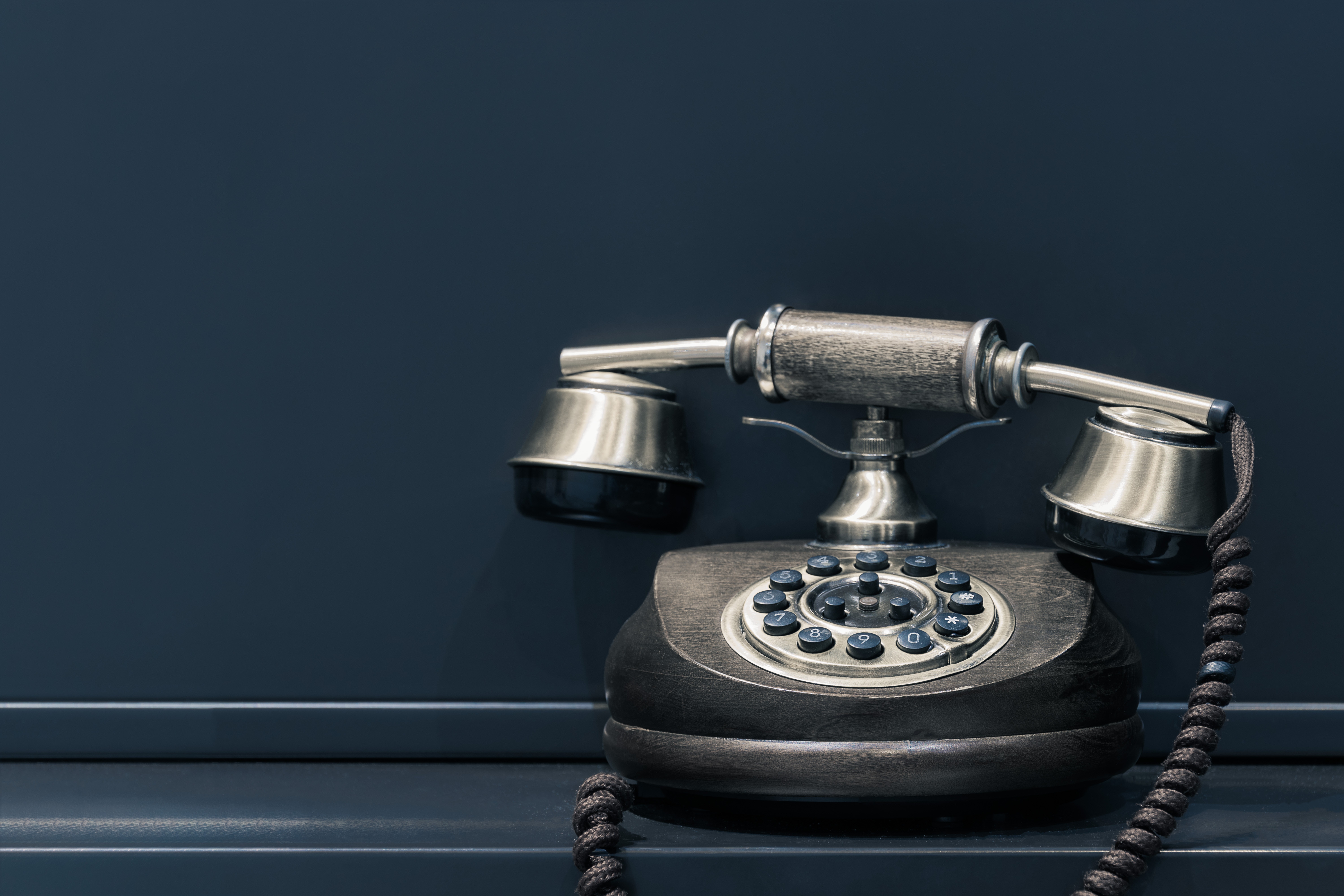an old, antique, black phone